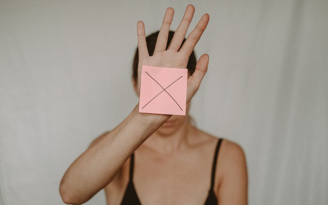 woman with a paper marked with x on her palm