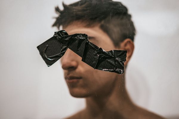 A man with a tape on top of an image of a man 