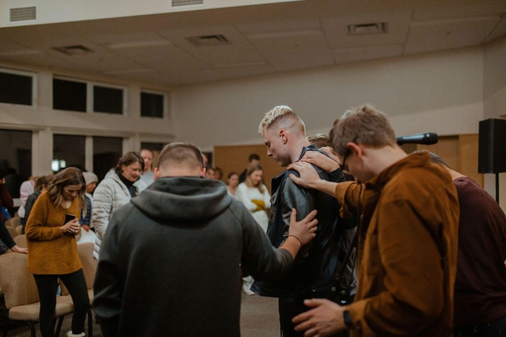 A group of people gathered around in a church, illustrating the importance of community in faith.
