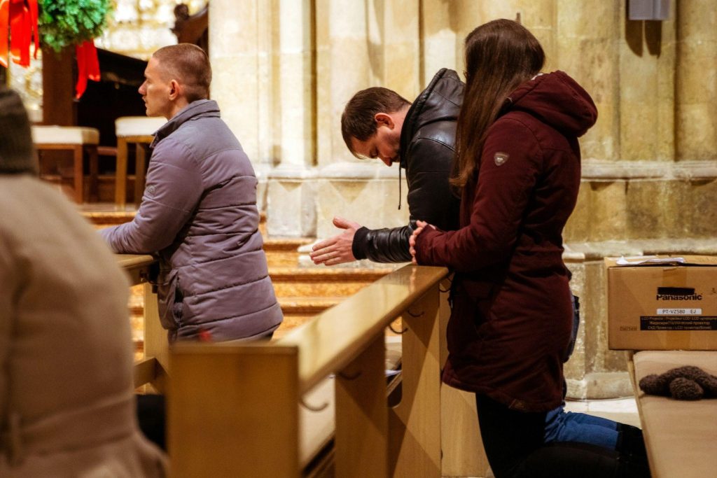 A group of people gathered around in a church, illustrating the importance of community in faith.