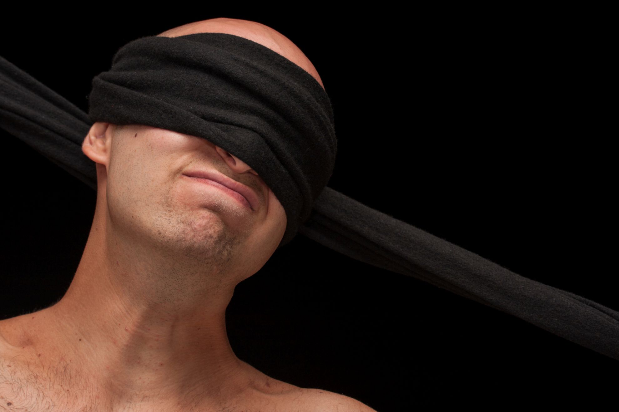 A man who’s been blindfolded.