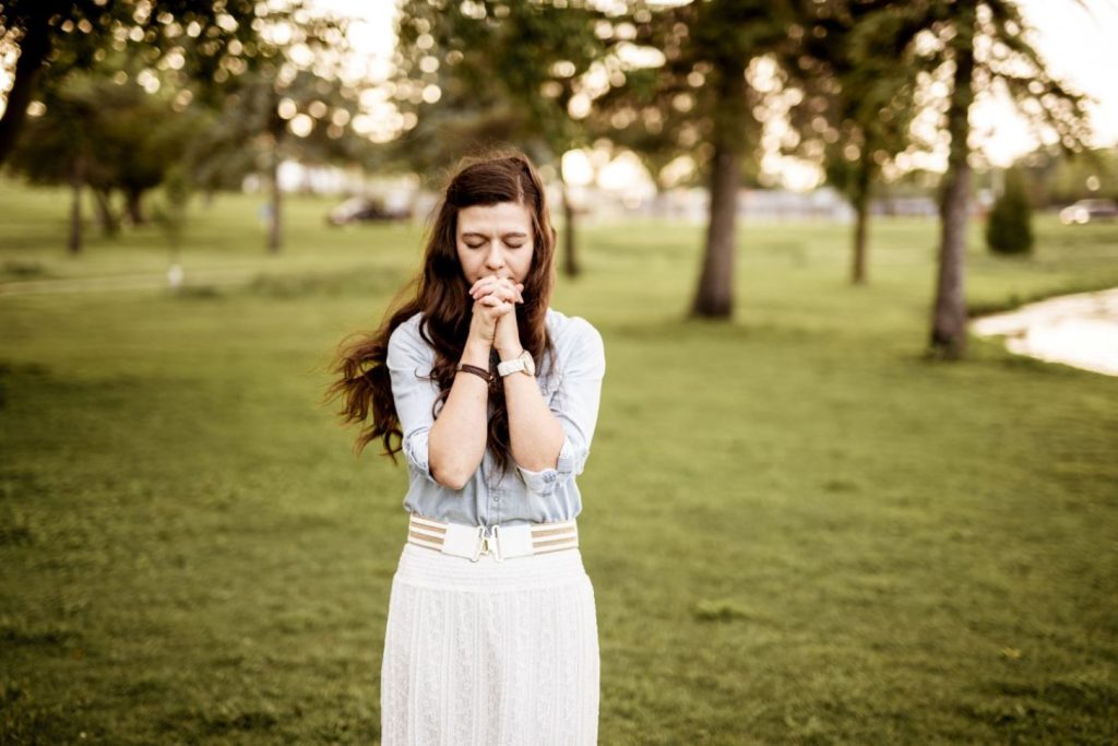 A woman praying for grace.